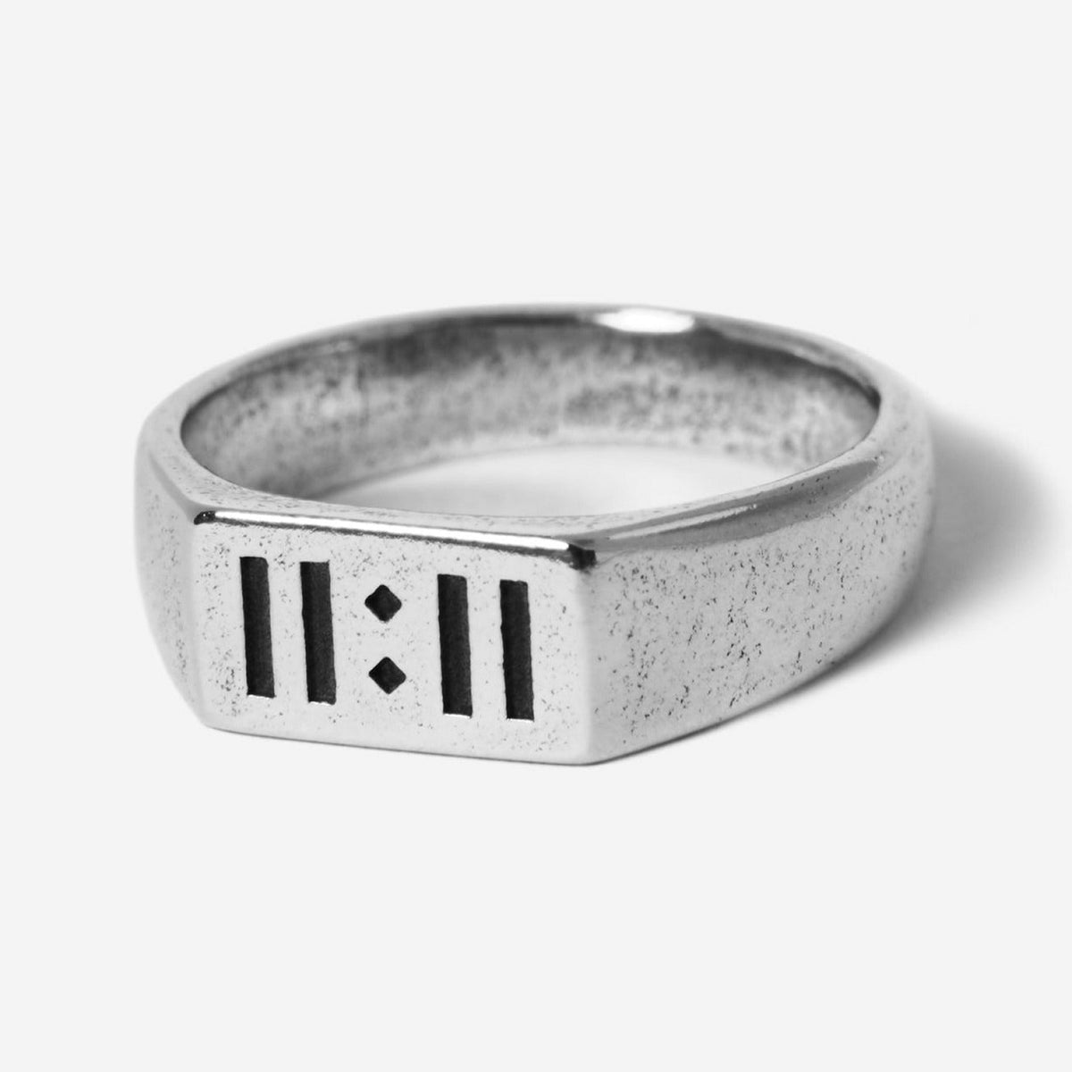 A sterling silver signet ring, the Momento Ring by Billie Jo, featuring a modern design with '11:11' engraved on its face. A piece of Australian men's jewellery.