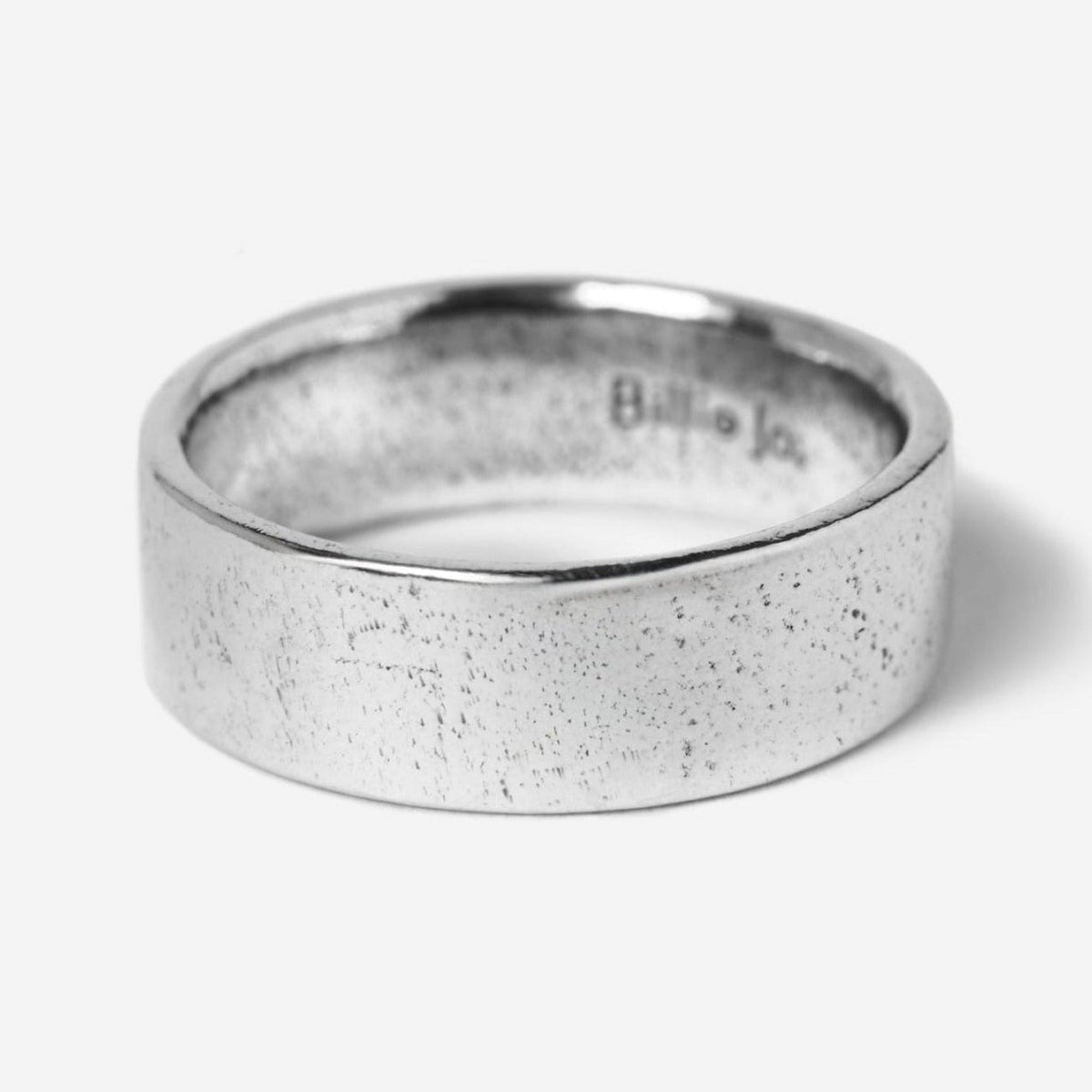 The Billie Jo Canvas Ring in sterling silver, a classic band with a subtly textured finish. A versatile piece of Australian men's jewellery.