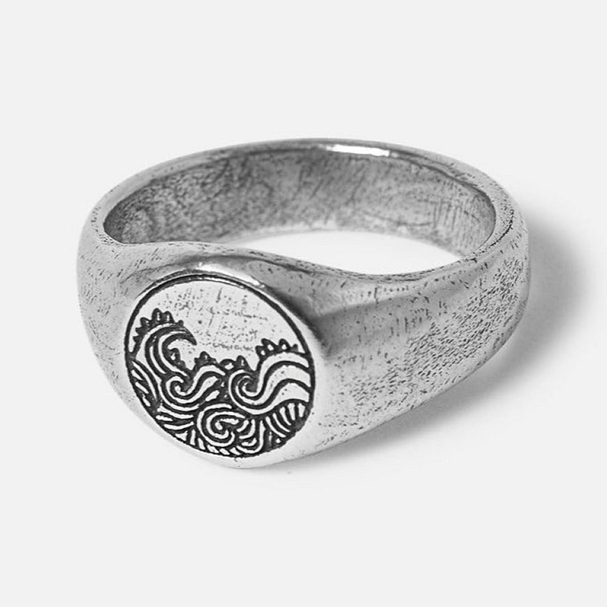 Billie Jo's sterling silver Current Ring for men, featuring a detailed, oxidised wave engraving on its circular face and a textured band.