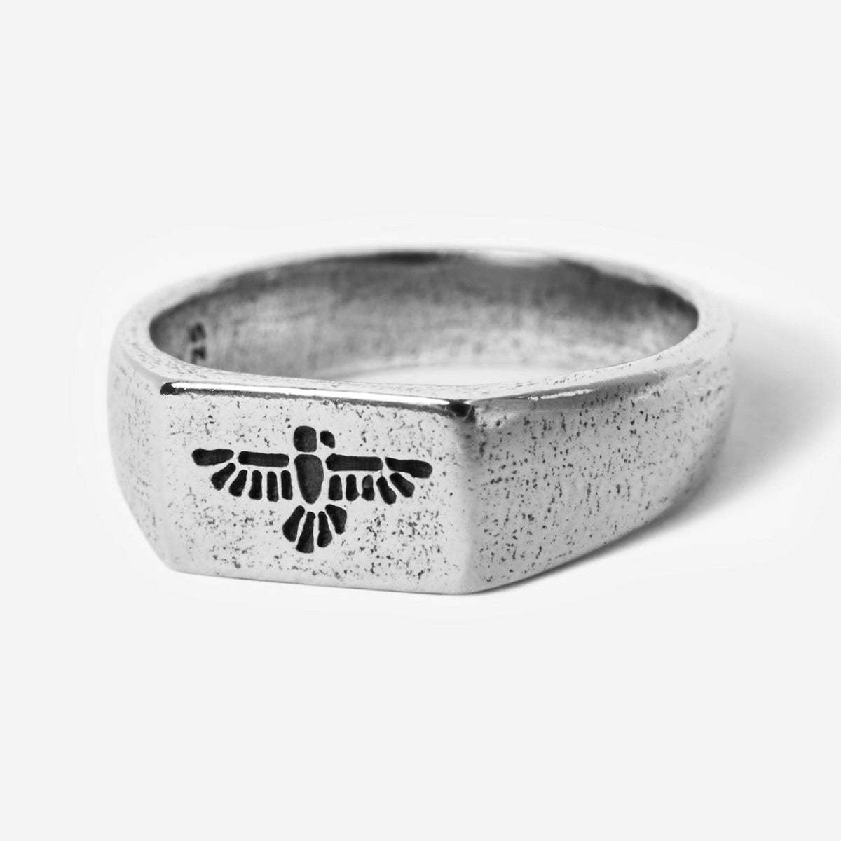 A sterling silver Essence Ring by Billie Jo, featuring a textured finish and a unique bird-like engraving on its face, shot against a clean white background.