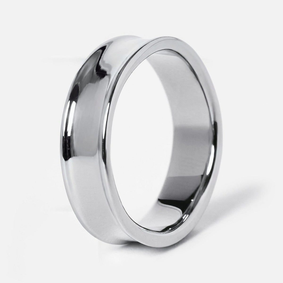 Men's Forge Ring in 316L stainless steel, silver finish, angled side view showing the dished band and raised edges