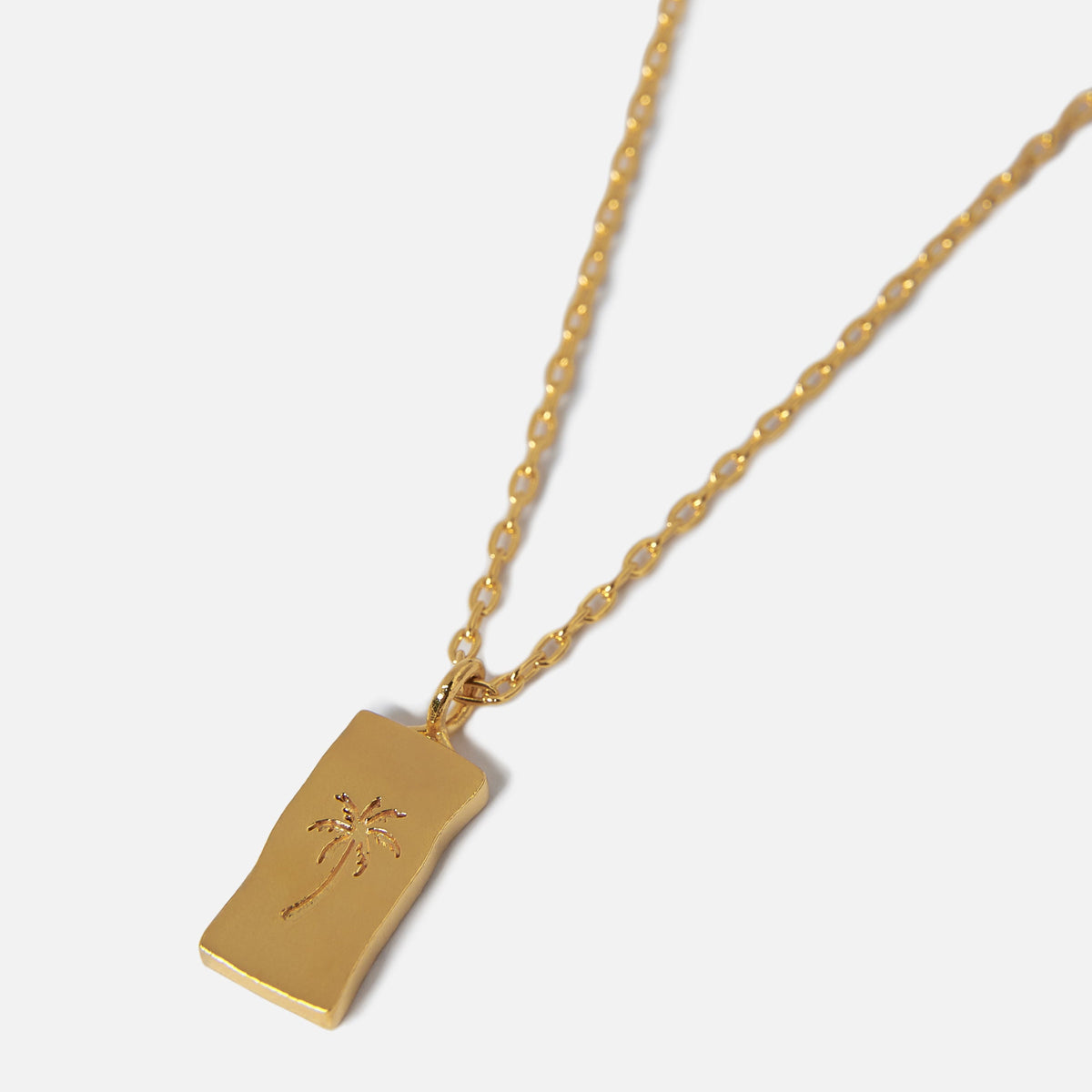 Billie Jo's Paradiso Pendant in 18k gold vermeil. A rectangular tag with a delicate palm tree engraving on a fine chain. Australian men's jewellery.