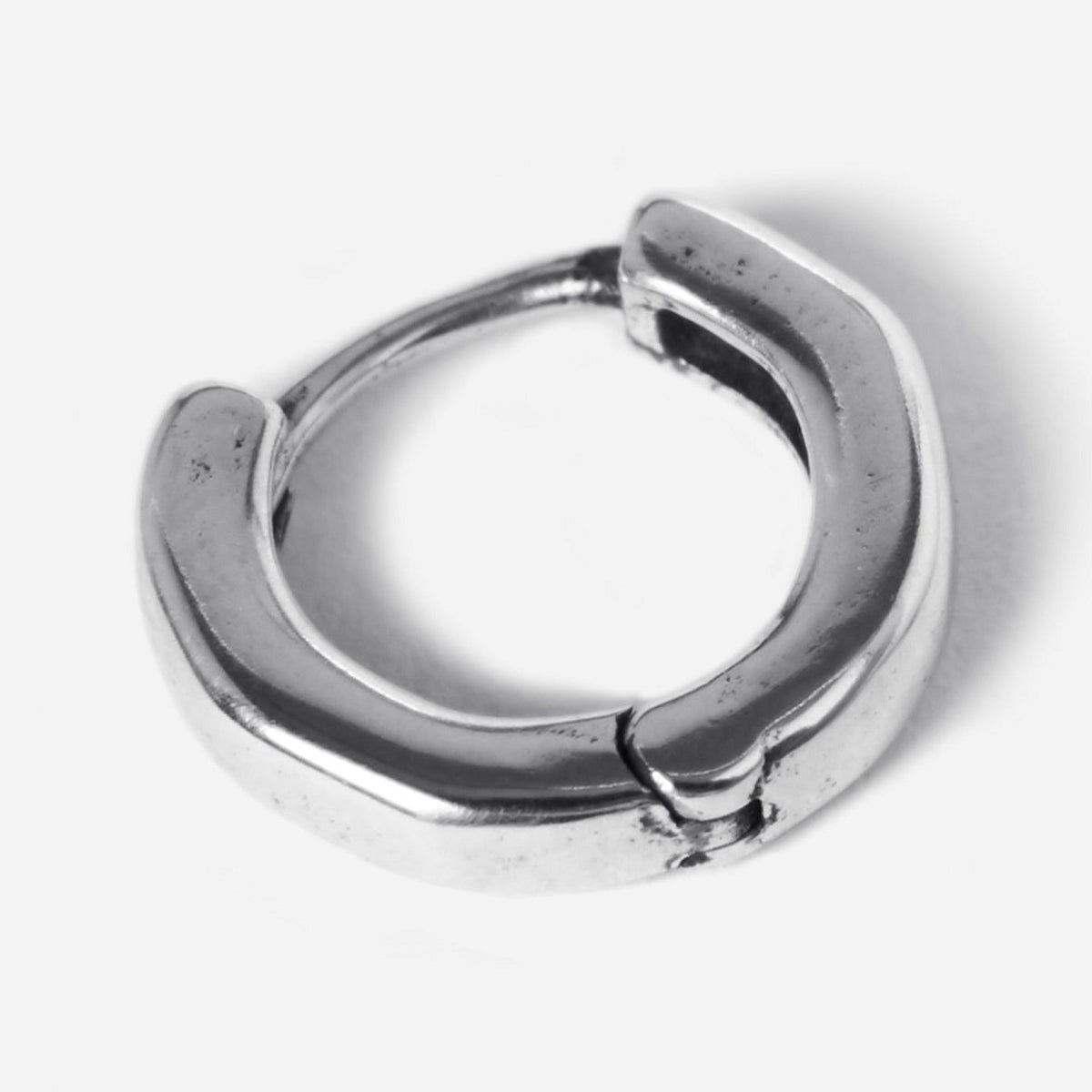 A detailed product shot of a single Billie Jo Lumina hoop earring in sterling silver, highlighting its classic, chunky design and secure clasp.