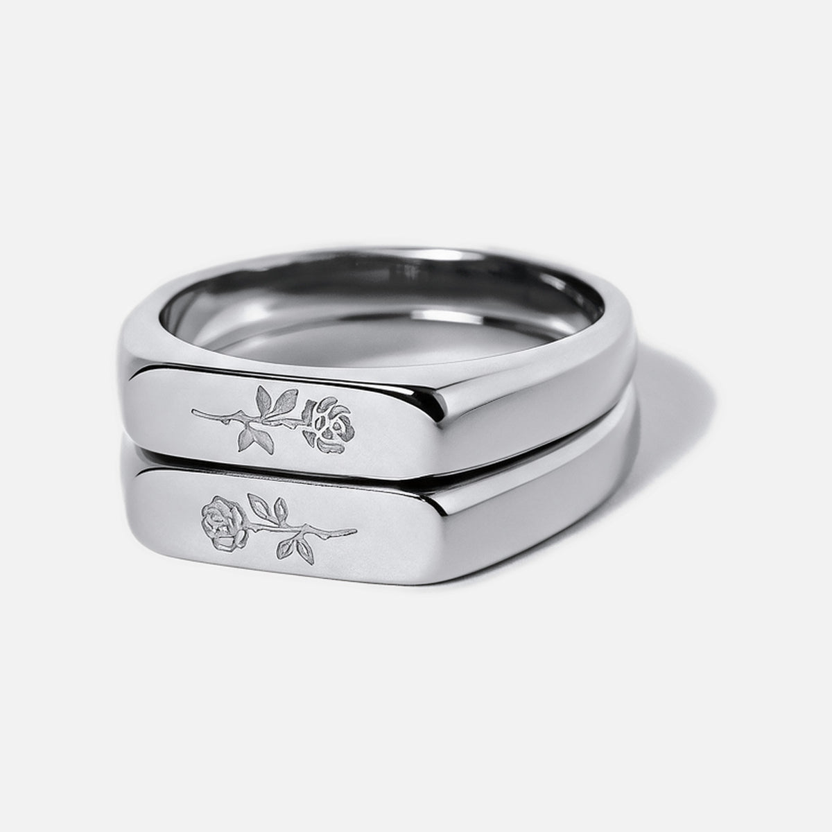 Men's Rosa Stackers in 316L stainless steel, silver finish, pair stacked, light and dark rose engraved, white background