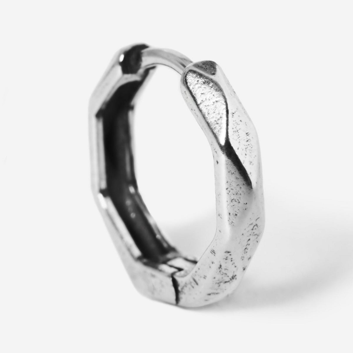 A single sterling silver Carve Earring from Billie Jo, shown standing to highlight its unique, hand-carved texture and modern, geometric shape. Men's jewellery.
