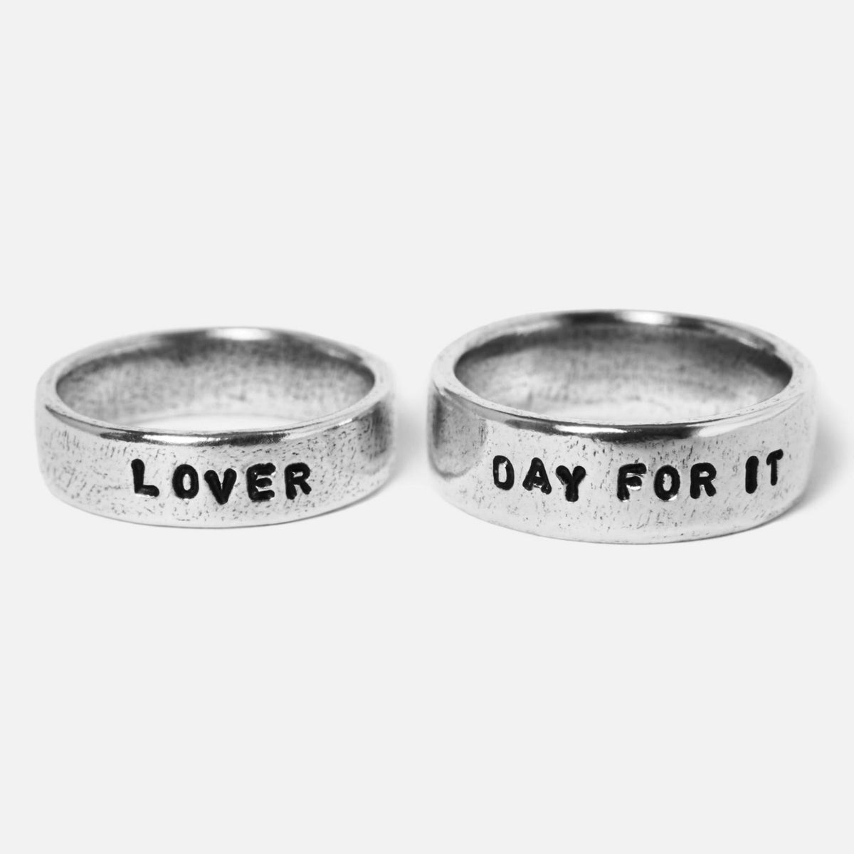 Two sterling silver Custom Stamped Rings by Billie Jo, engraved with '''LOVER''' and '''DAY FOR IT''', showcasing personalised Australian men's jewellery.