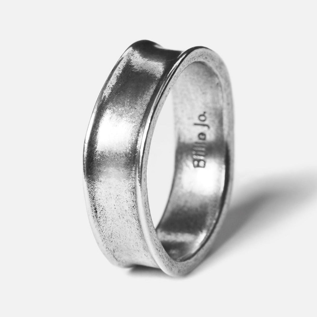 A sterling silver Forge Ring by Billie Jo, with a unique forged and hammered texture creating a modern, concave shape. Shot on a clean white background.