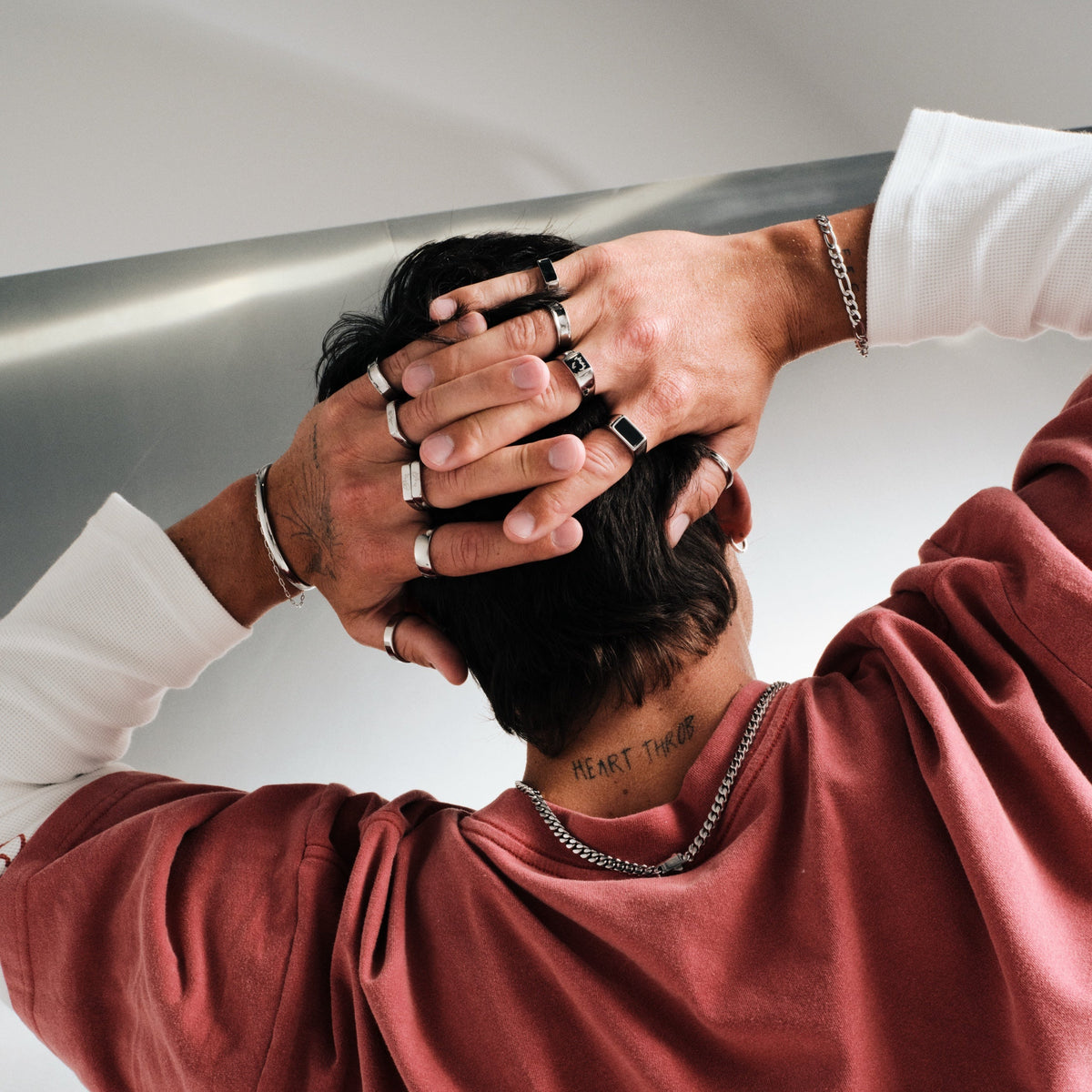 Men's Onyx Ring in 316L stainless steel, silver finish, in a stack, hands clasped behind his head, shot from behind