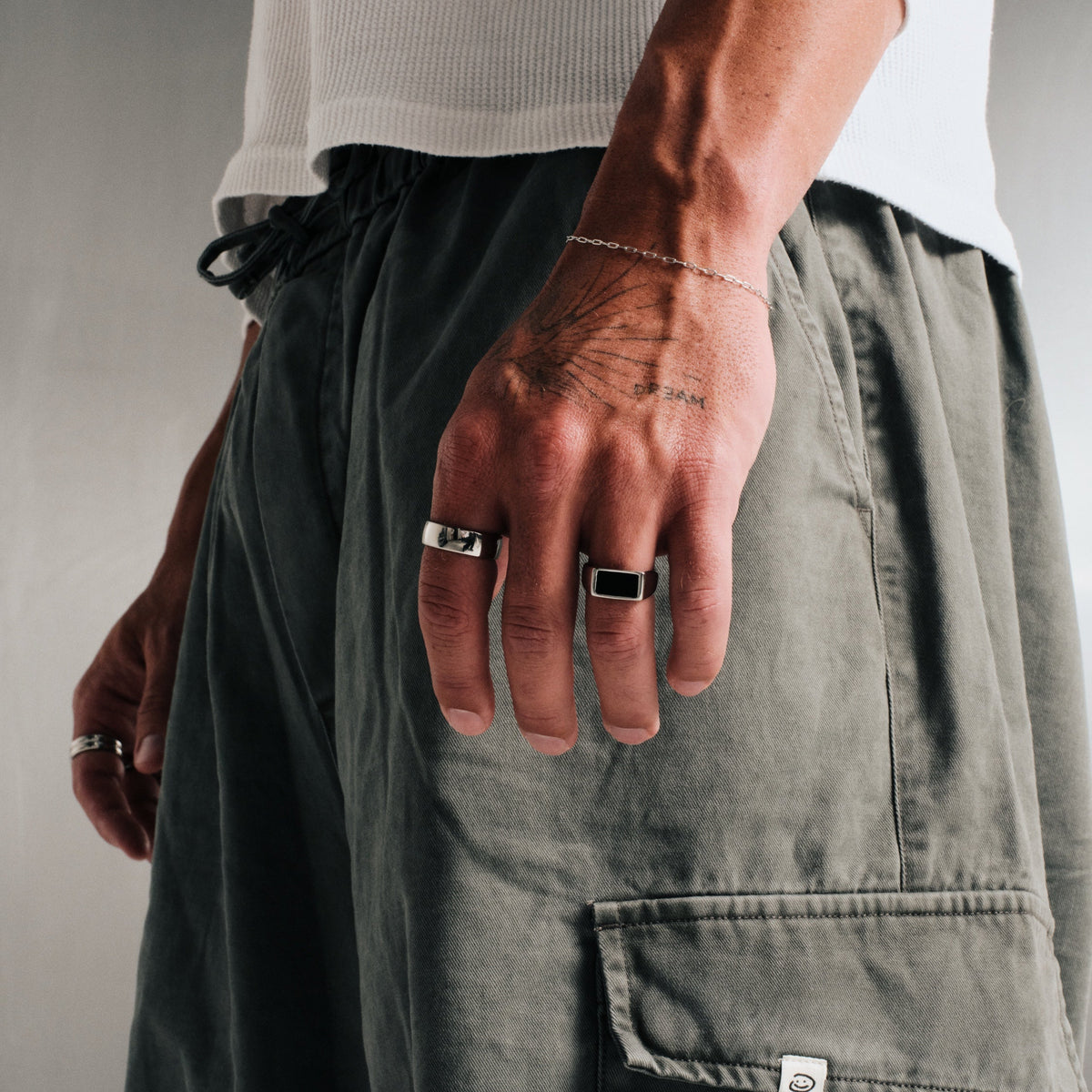Men's Onyx Ring in 316L stainless steel, silver finish, worn on the ring finger, hand by his side, other hand behind