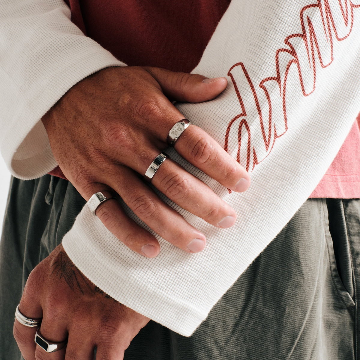 Men's Revival Ring in 316L stainless steel, silver finish, worn on his right index finger, right hand over left forearm