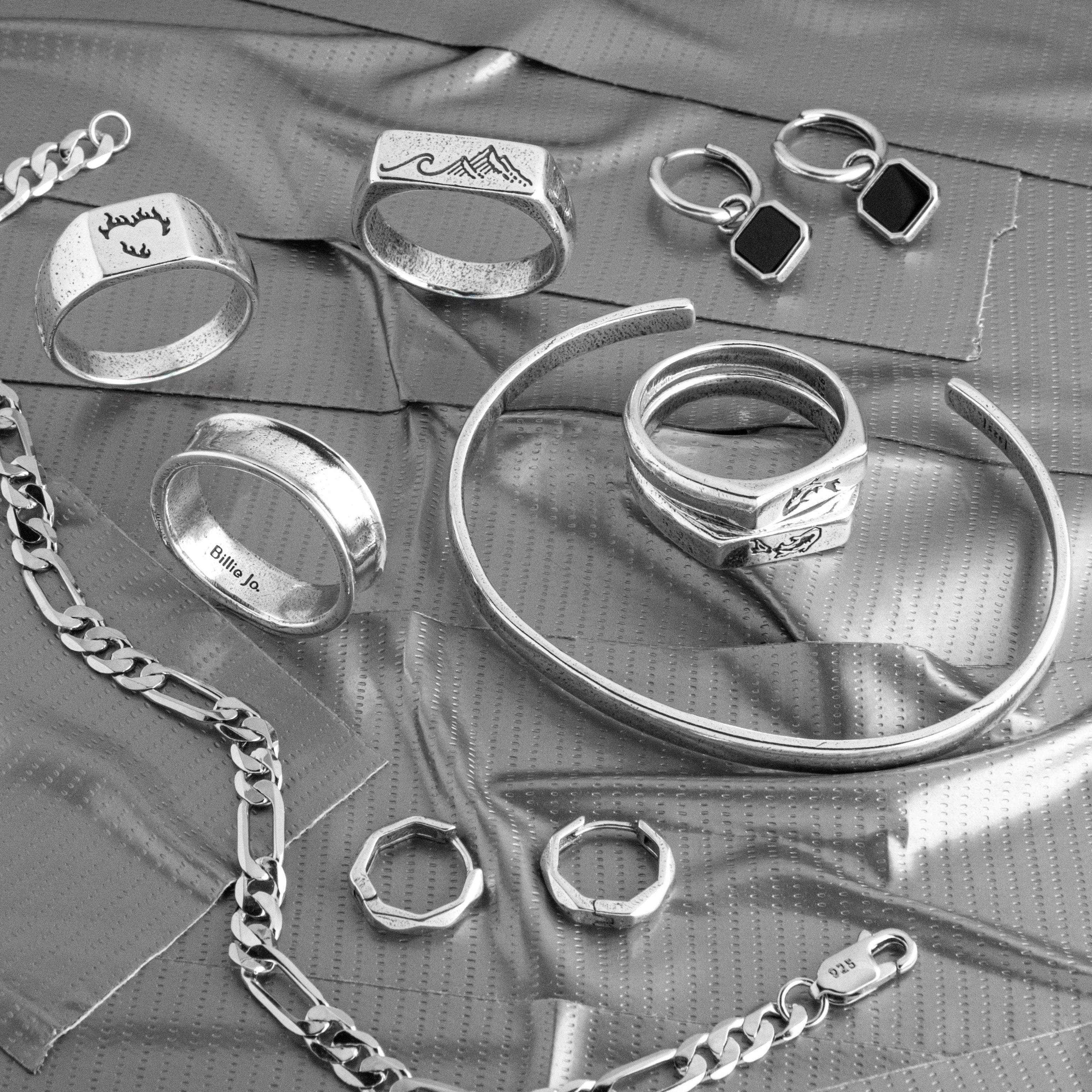  Mens jewellery gift guide flat lay of Billie Jo sterling silver rings, chains and bracelets being chosen as a gift for him