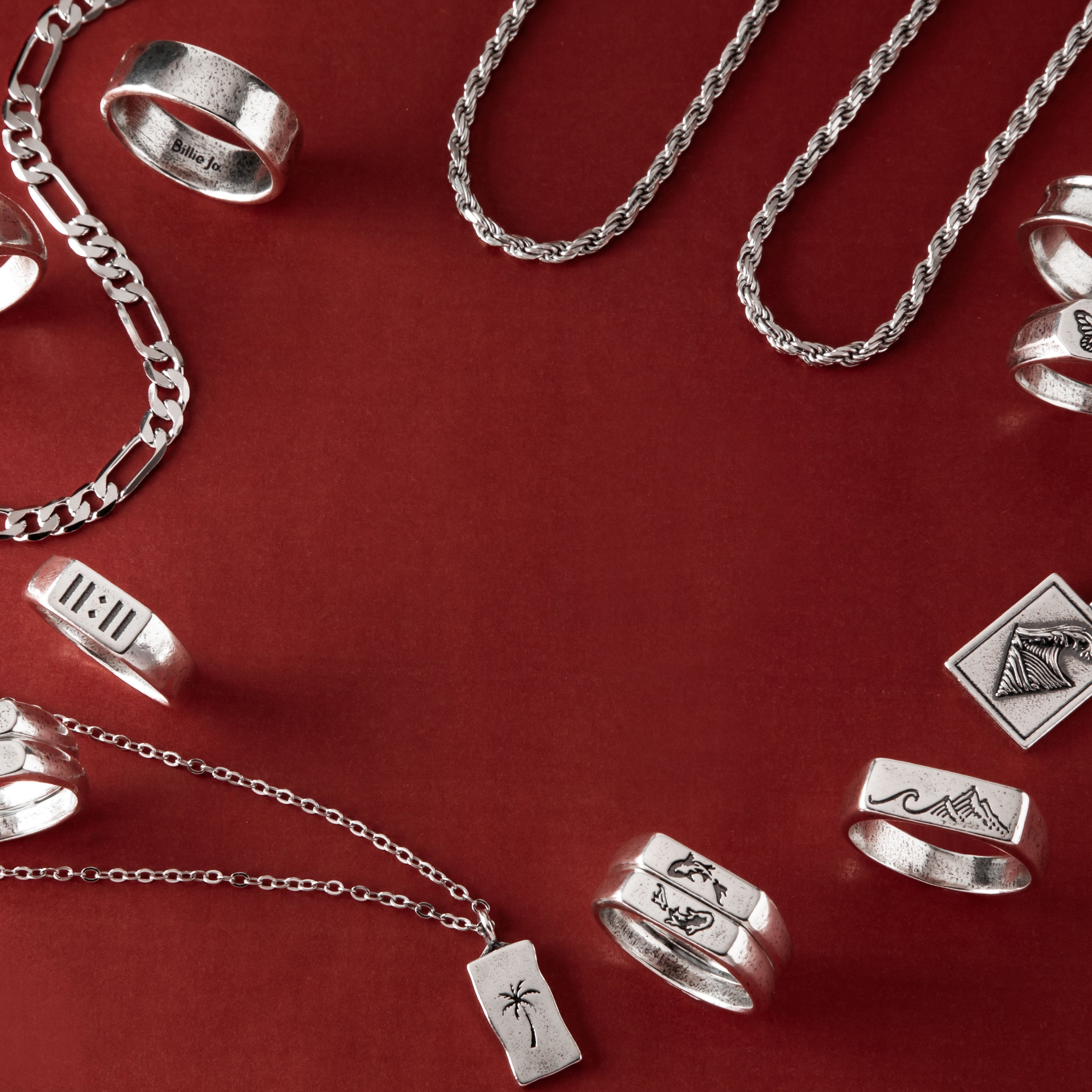 Mens rings stacked on male hand, Billie Jo sterling silver rings styled for everyday wear on the Gold Coast