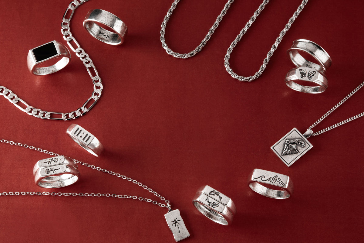Mens rings stacked on male hand, Billie Jo sterling silver rings styled for everyday wear on the Gold Coast