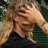 Classic Billie Jo rings captured in natural lighting on skin.