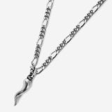 Chilli pendant necklace on gold chain against beige background