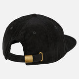 A black corduroy baseball cap shown from the back, featuring an adjustable strap with a brass buckle and a curved brim, against a plain light background.