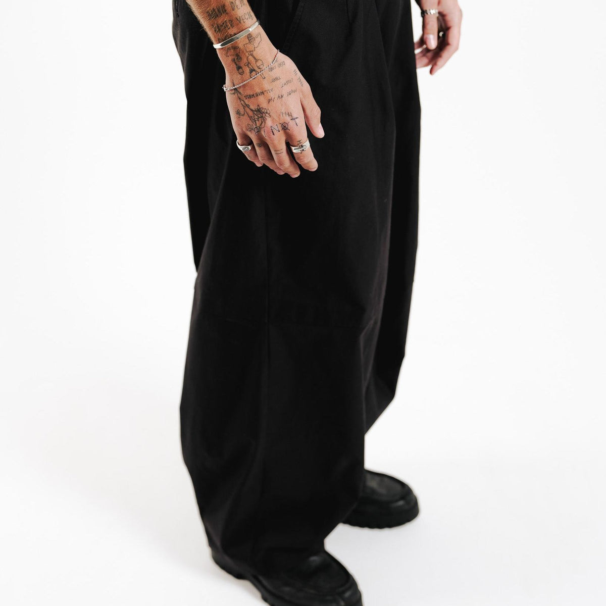 A full-length shot of a model wearing the Billie Jo Slim Rope Bracelet, showcasing how this versatile silver jewellery piece complements a modern, casual outfit.
