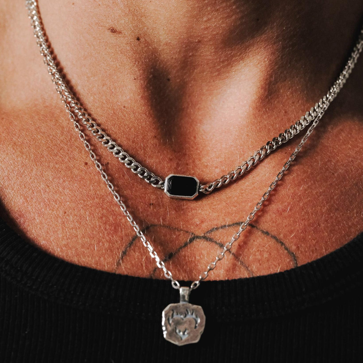 The Ember Pendant layered with a black onyx necklace, demonstrating how to style multiple pieces of Billie Jo men's jewellery for a complete look.