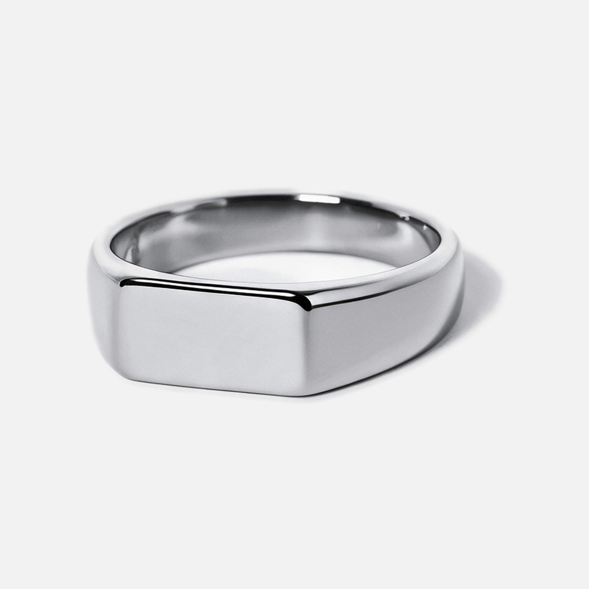 Men's Genesis Ring in 316L stainless steel, silver finish, angled view of the blank flat face, white background