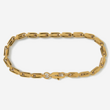 Gold chain bracelet on a light gray background