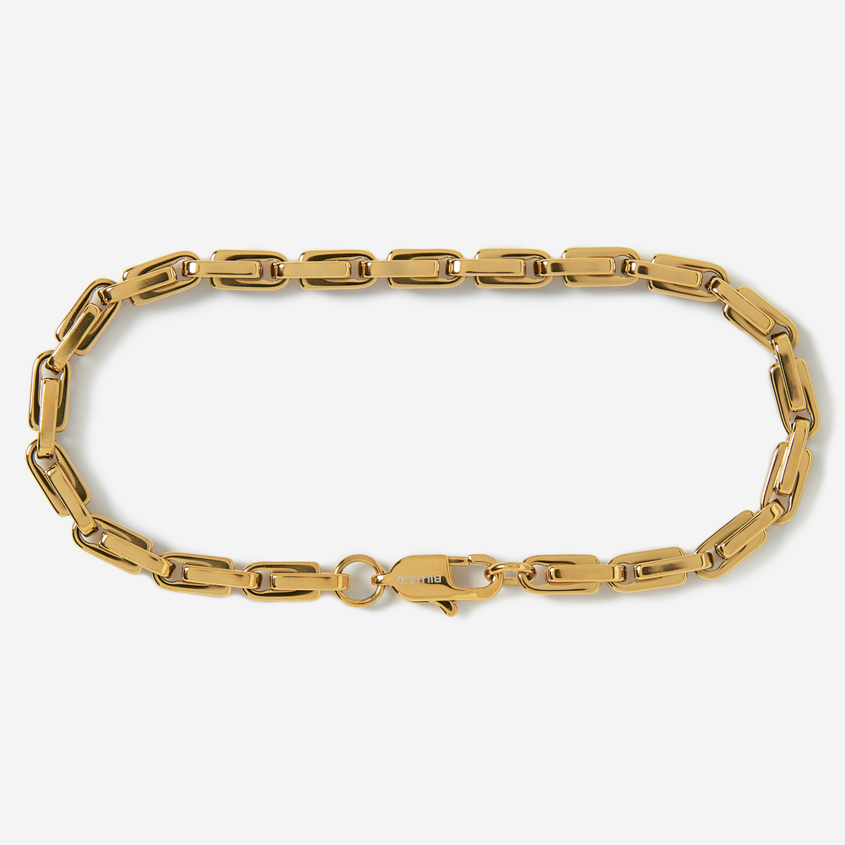 Gold chain bracelet on a light gray background