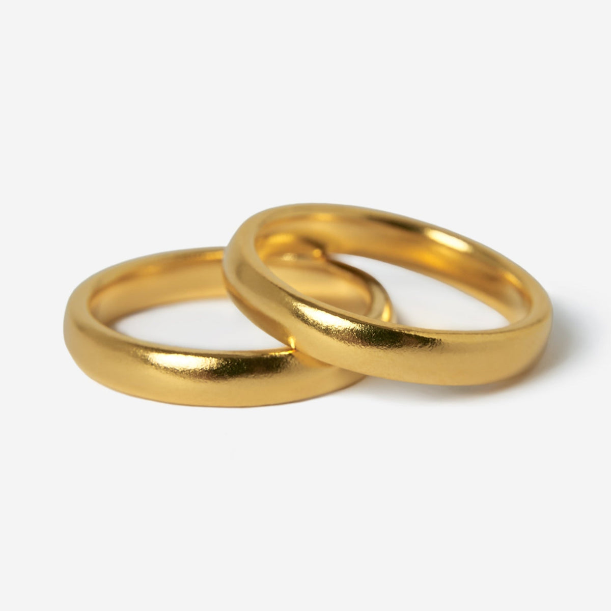 Two gold stacker rings from Billie Jo Jewellery, with a smooth, polished finish, are shown overlapping on a clean white background. The 18k gold vermeil has a warm, rich colour.