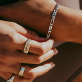 A model wearing a polished silver tone  Figaro chain bracelet from Australian jewellery brand Billie Jo
