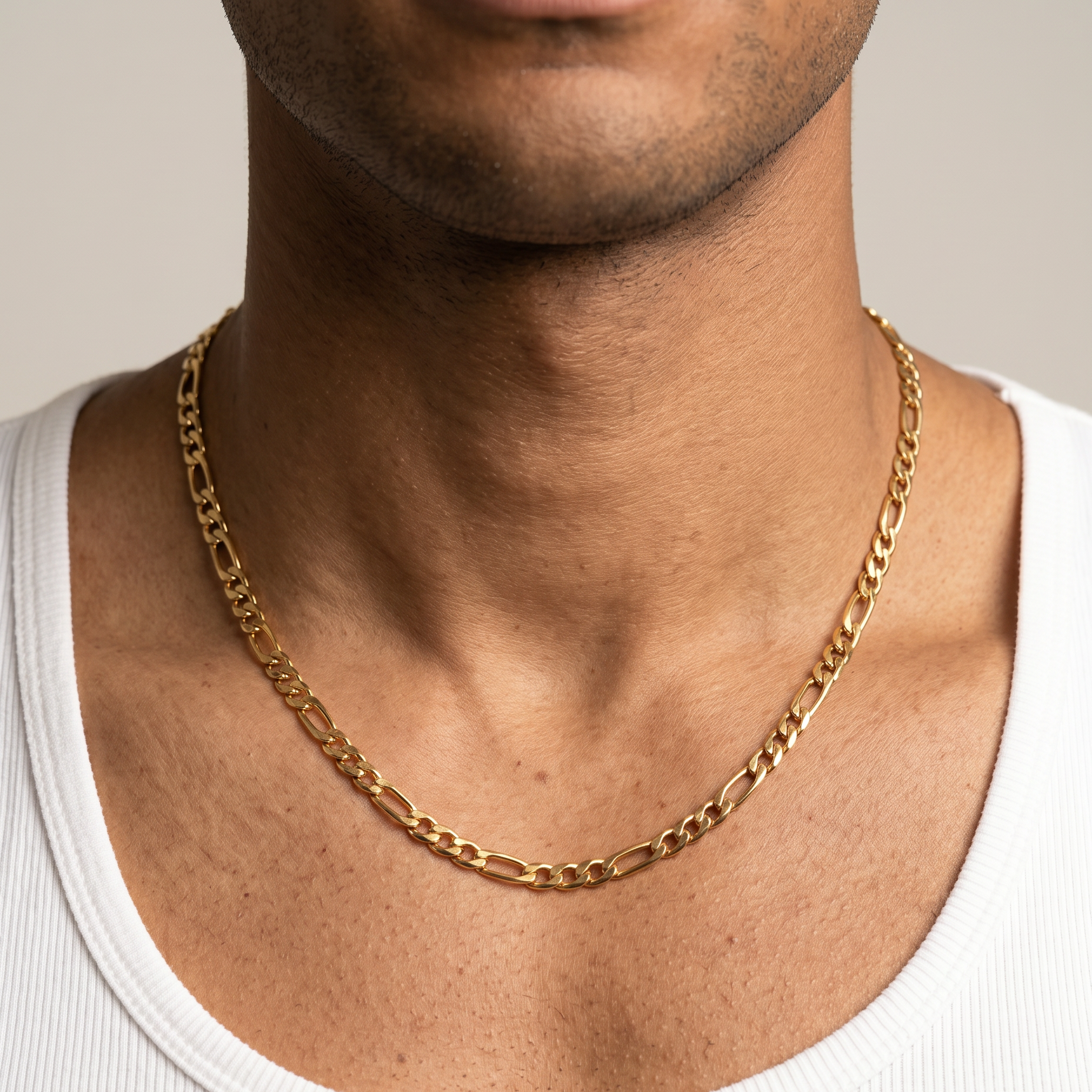A gold stainless steel slim Figaro chain necklace from Australian jewellery brand Billie Jo, worn by a male model, a waterproof sweat proof everyday necklace and the perfect gift for him.