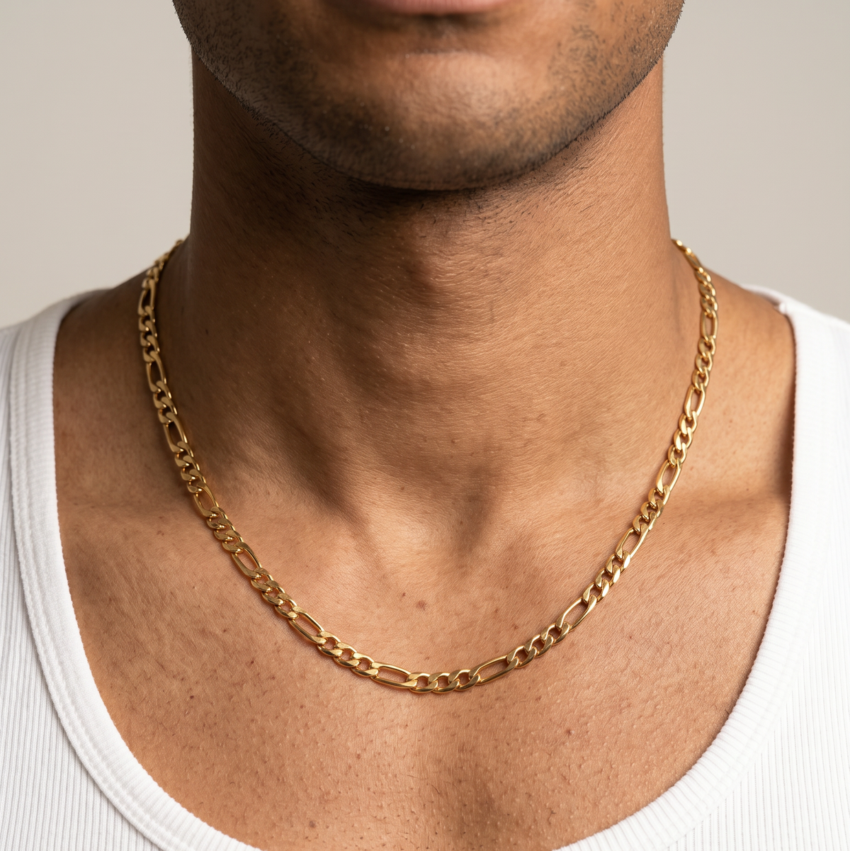 A gold stainless steel slim Figaro chain necklace from Australian jewellery brand Billie Jo, worn by a male model, a waterproof sweat proof everyday necklace and the perfect gift for him.