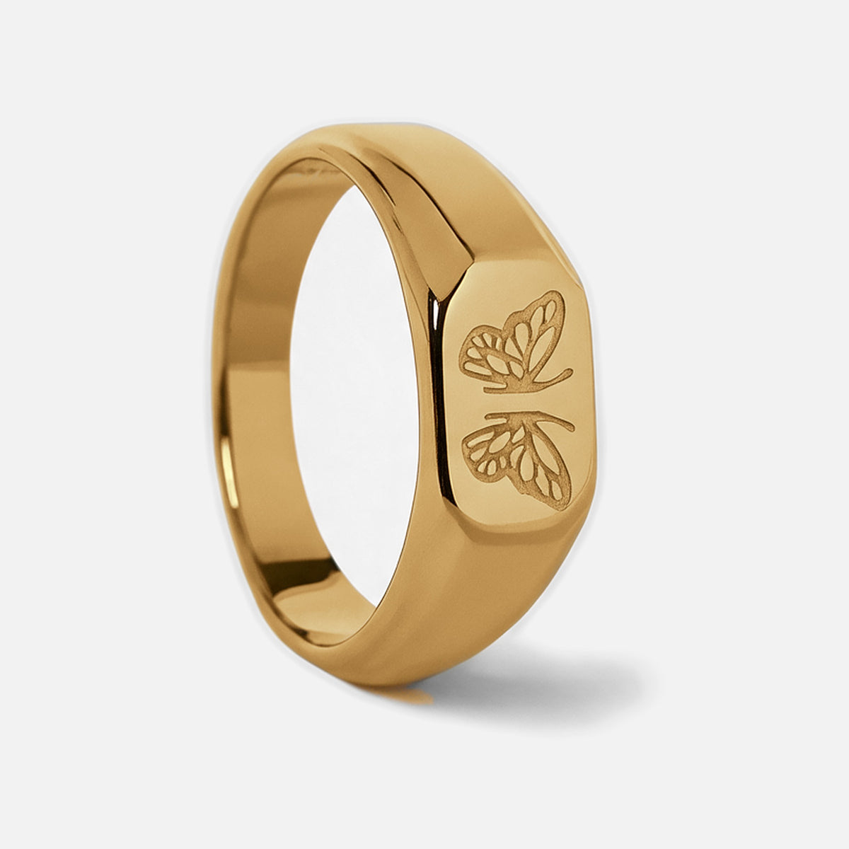 Men's Gold Revival Ring in 18k gold infused stainless steel, upright side view of the butterfly face, white background