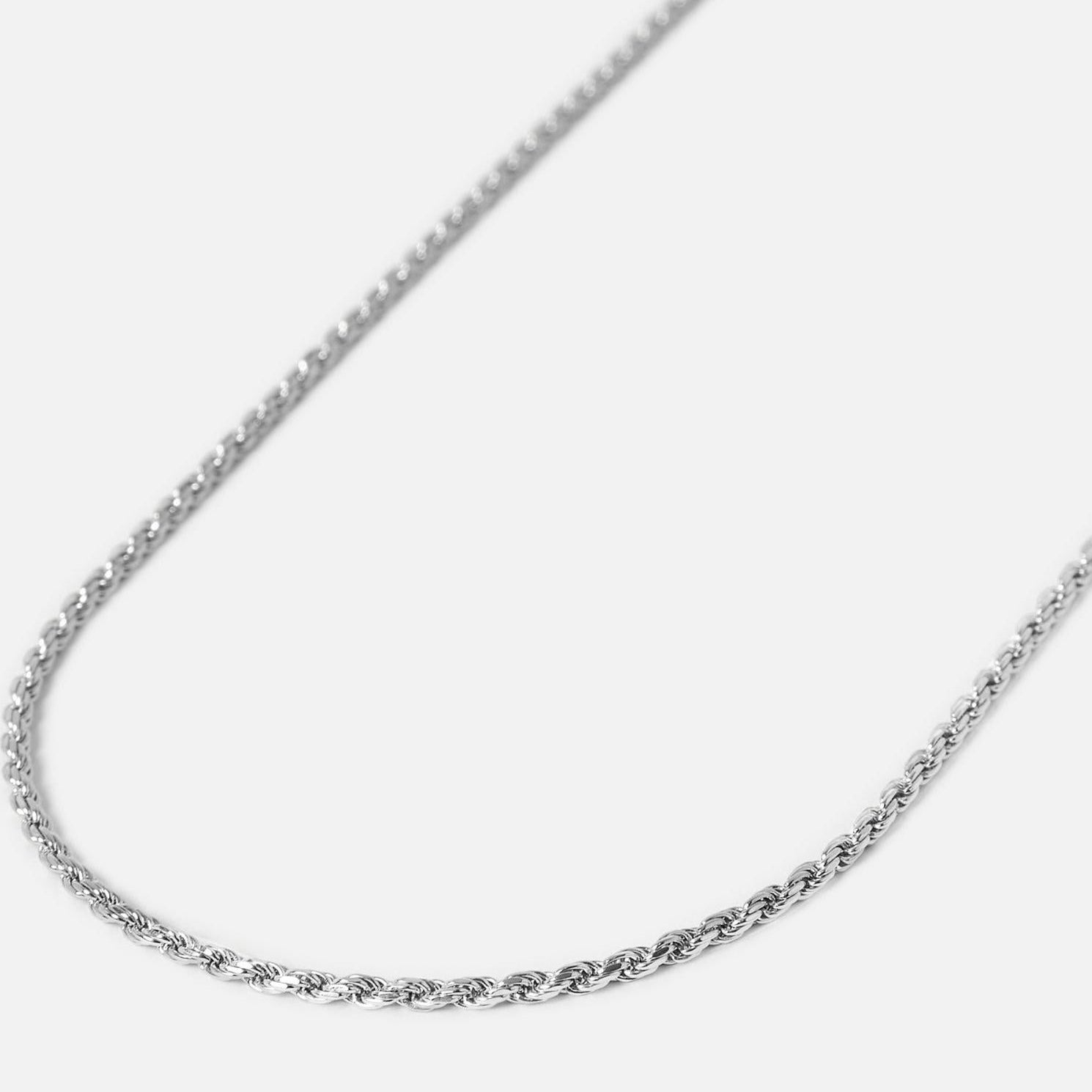 A delicate silver rope chain necklace displayed on a plain white background.