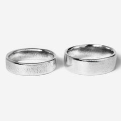 A pair of men's sterling silver rings from the Billie Jo Canvas & Serenity set, shown on a clean white background. The Canvas ring features a unique textured finish, while the Serenity ring has a classic polished look, offering versatile Australian jewellery styling.