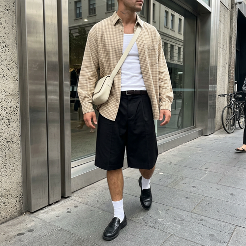 Fashion-forward style: layered overshirt, tailored shorts and loafers
