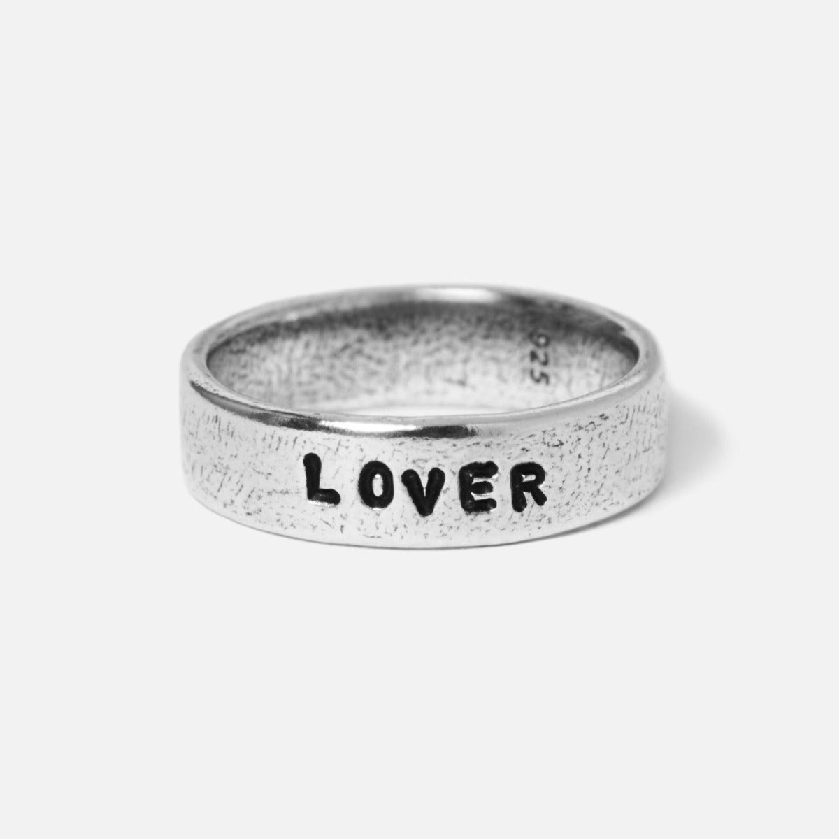 A close-up of the Billie Jo Custom Stamped Ring in sterling silver, featuring the word '''LOVER''' hand-stamped for a unique, personal touch.