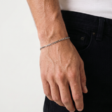 A close up of a silver stainless steel men's Figaro chain bracelet from Australian jewellery brand Billie Jo, worn against skin showing waterproof everyday style.