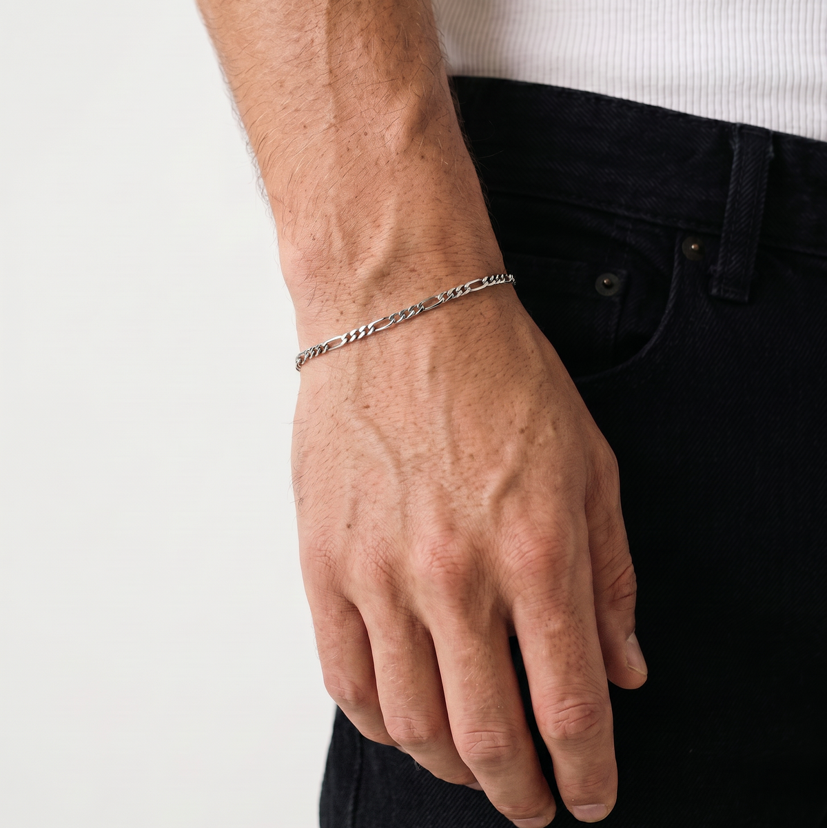 A close up of a silver stainless steel men's Figaro chain bracelet from Australian jewellery brand Billie Jo, worn against skin showing waterproof everyday style.