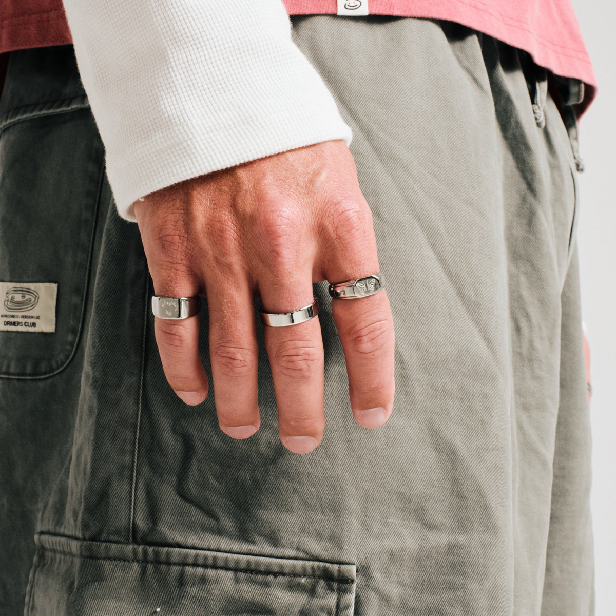 Men's Serenity Ring in 316L stainless steel, silver finish, worn on the middle finger, hand hanging by his side