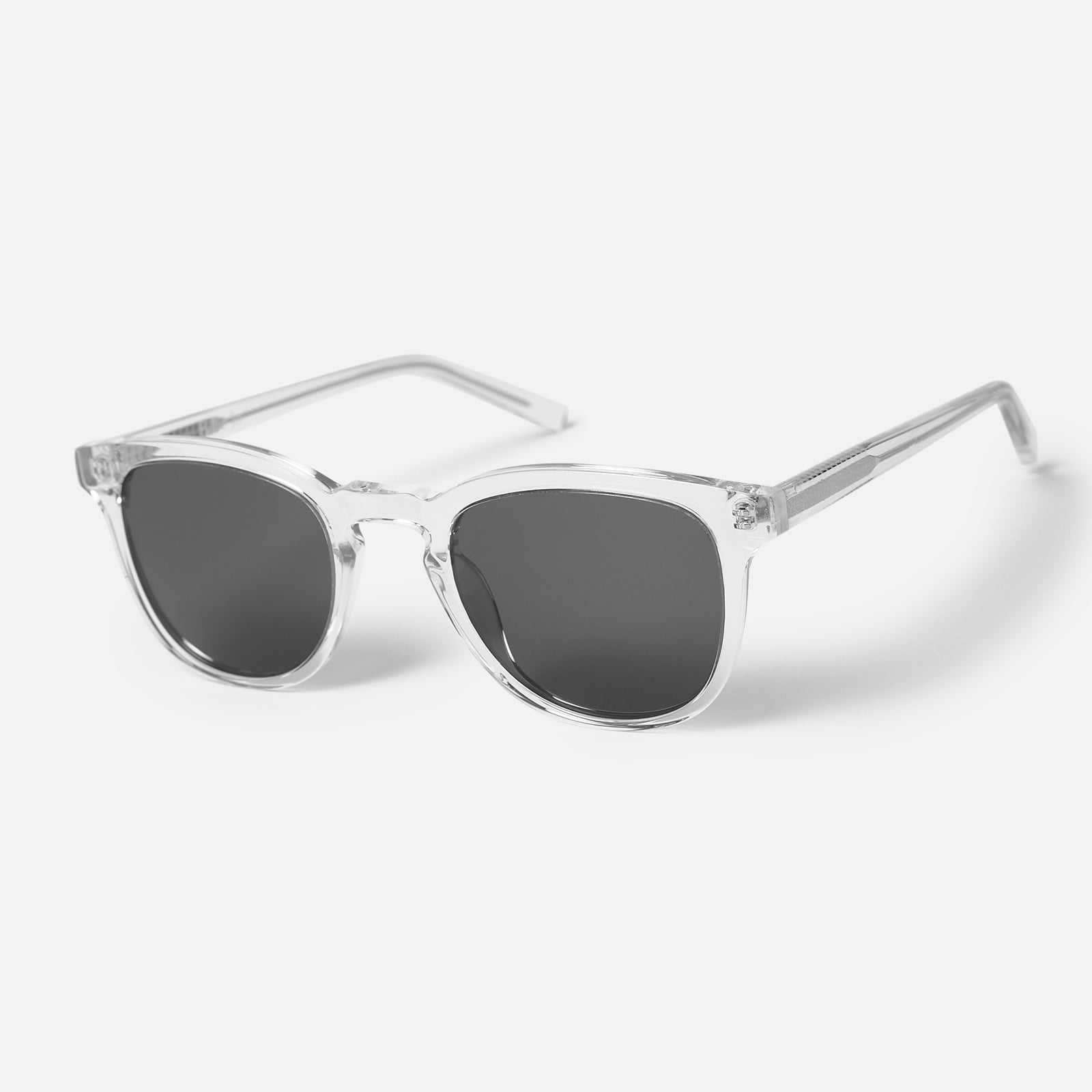 A pair of Billie Jo's free polarised sunnies with clear frames and dark lenses, angled to show the classic, unisex design. Modern Australian men's jewellery.