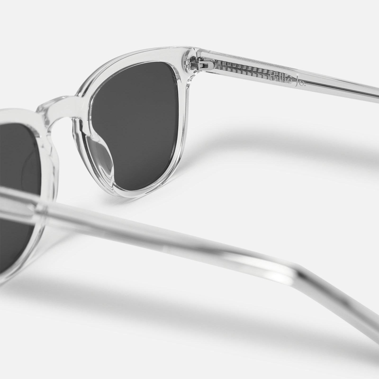 A close-up of the Billie Jo free polarised sunnies, showing the clear frame and the brand's logo etched into the arm. Quality men's eyewear from Australia.
