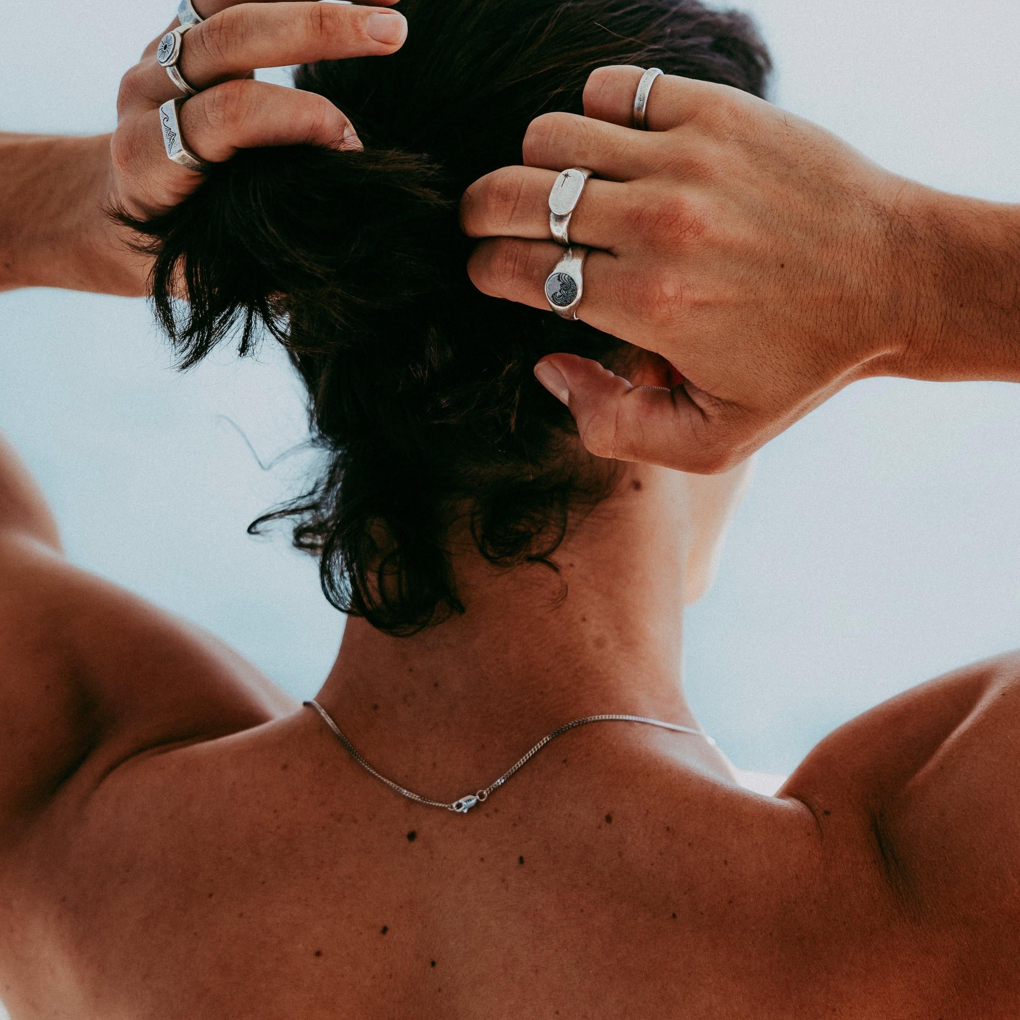 Close-up of Billie Jo ring stack on fingers with soft light